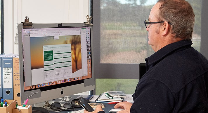 Producer sitting at computer with MLA dashboard on screen